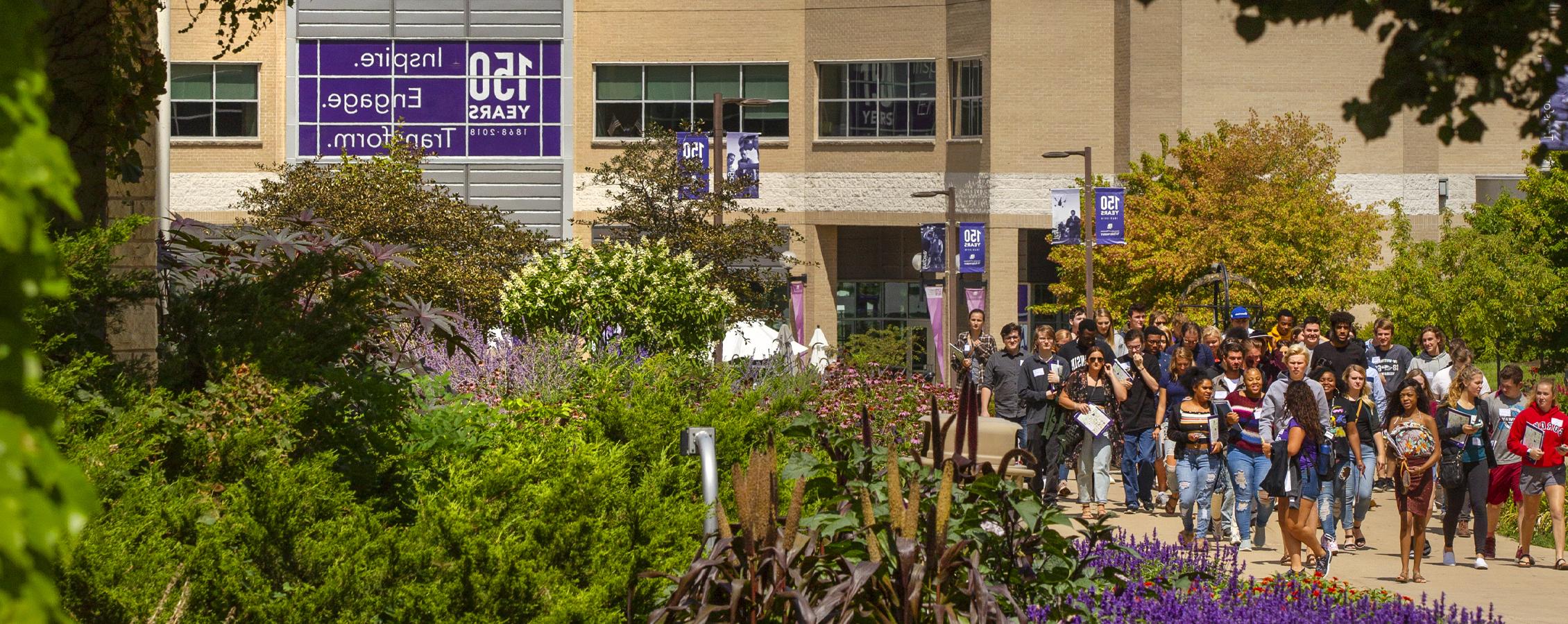 A campus tour in front of the University Center during summer.